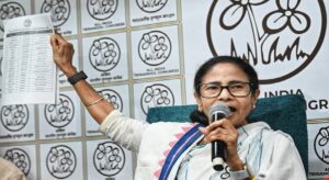 Didi’s 10 Pledges: Lakshmi Bhandar Hiked to ₹20K, 7 New Districts & Healthcare at Doorstep!
